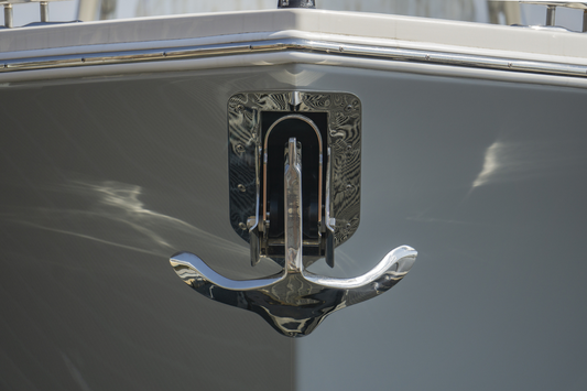 Front close up view of the bow of a boat with a mounted stainless steel anchor